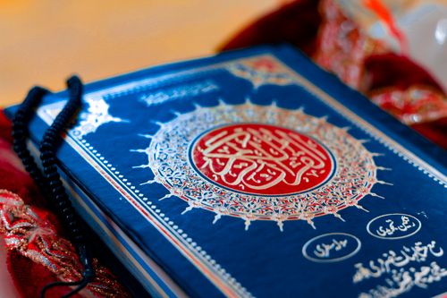 Photograph of a printed Mushaf with a blue cover used for meaning study